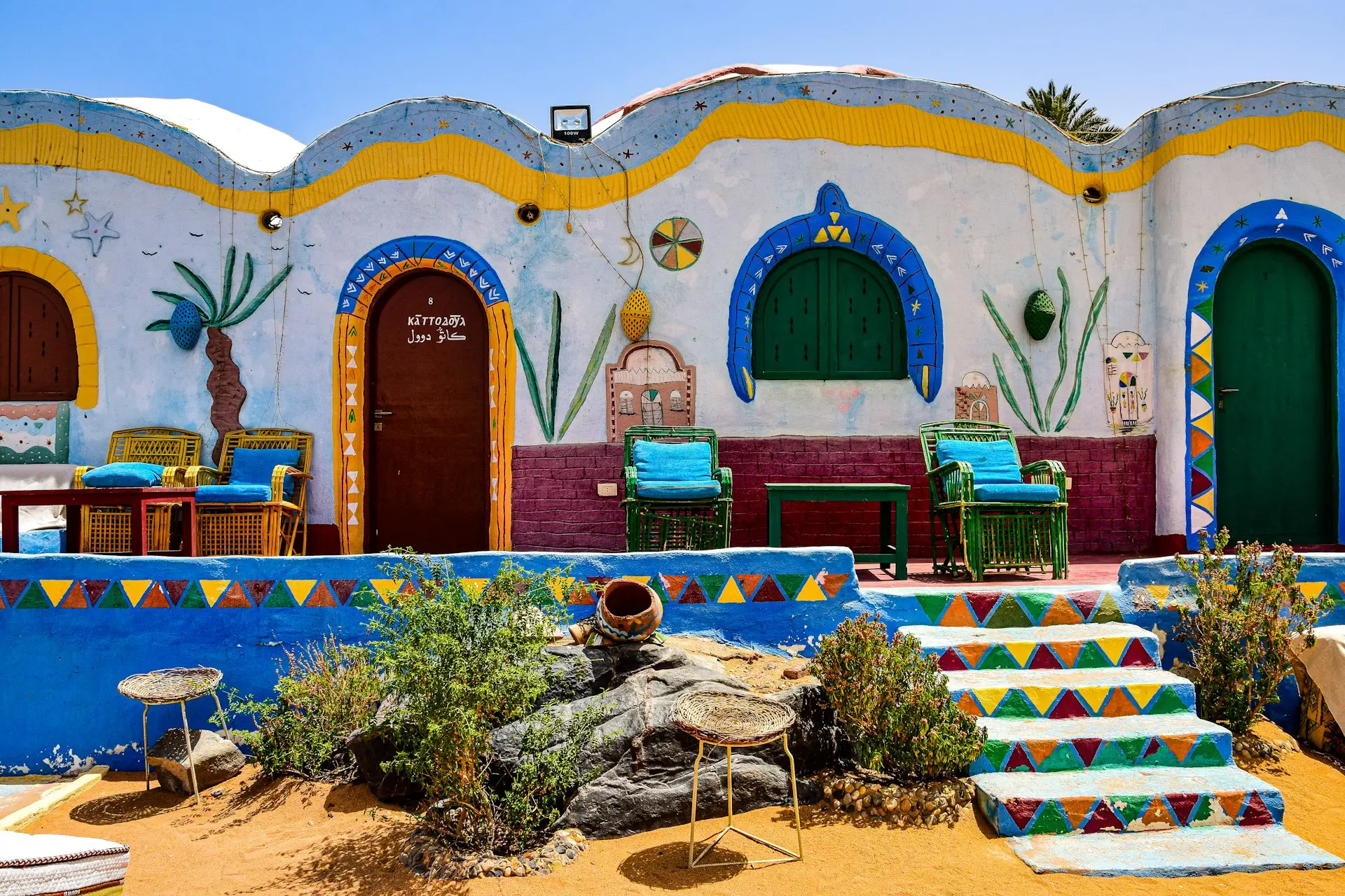 a colorfully painted building with steps leading up to it